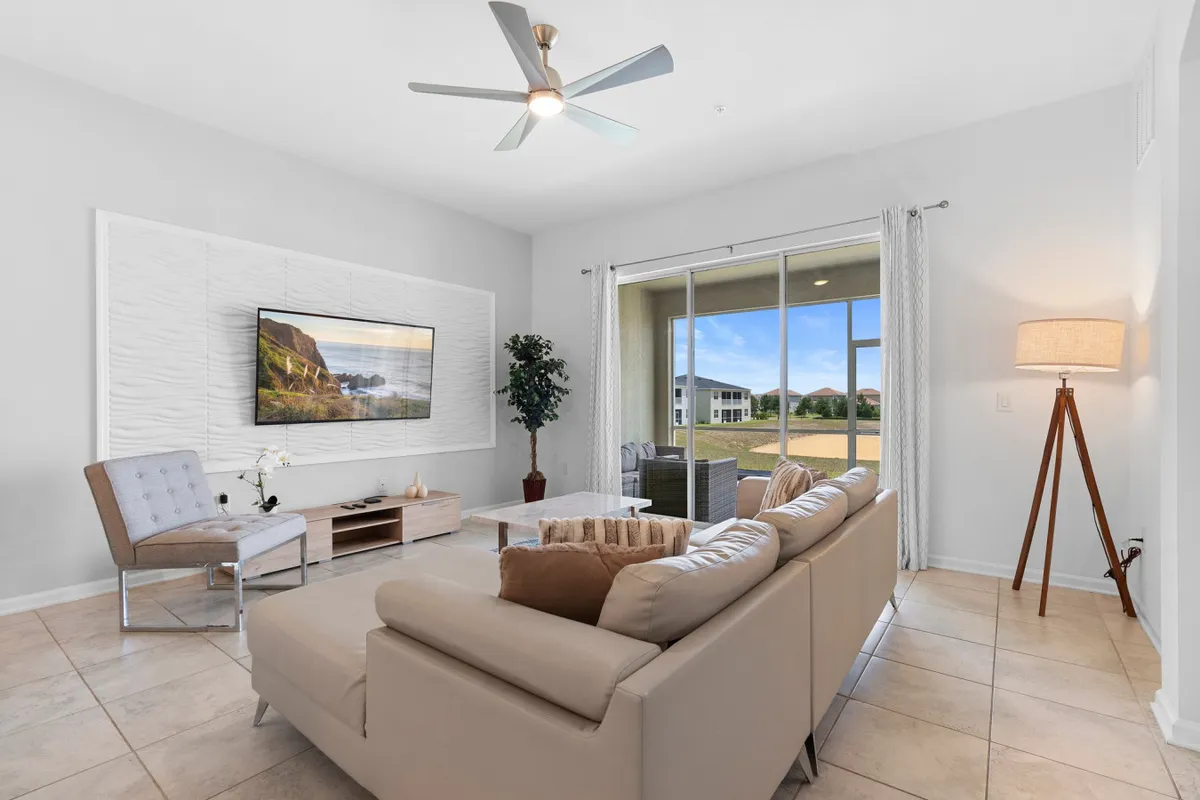 A comfortable seating area with a plush sofa faces a TV, with a coffee table and a window view to the side. The arrangement invites relaxation and entertainment, echoing the section's mention of movie nights and quiet moments.
